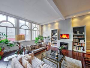 a living room with a couch and a fireplace at New York Style Apartment with the City Life! in Cape Town