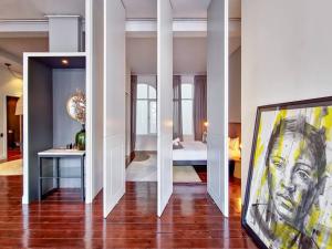 a room with a painting of a man on the floor at New York Style Apartment with the City Life! in Cape Town
