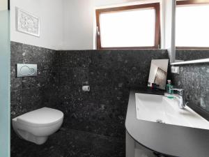 a bathroom with a white toilet and a sink at Ochsen Hotel Am Mehlsack in Ravensburg