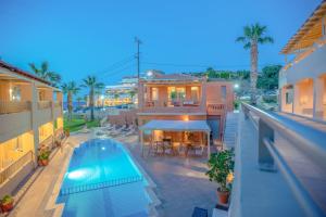 an overhead view of a swimming pool and a house at Anatoli Apartments in Agia Pelagia