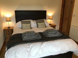 a bedroom with a bed with towels on it at The Stables and Granary at Shawbroom Farm in Cheswardine