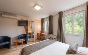 a hotel room with a bed and a window at Logis Au Poisson d'Argent in Le Mesnil-en-Vallée