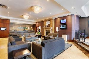 a living room with couches and a fireplace at Sandman Hotel Vancouver Downtown in Vancouver