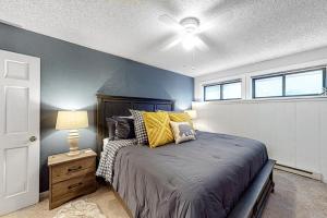 a bedroom with a bed and a ceiling fan at Ponderosa 2A Permit #3,01630 in Crested Butte