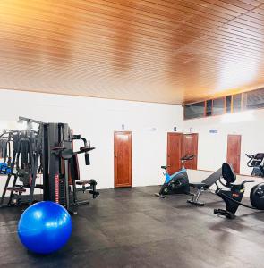a gym with several treadmills and exercise bikes at Sajjoys in Varkala