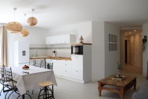a kitchen and dining room with a table and chairs at La Villa des Moulins in Calvisson