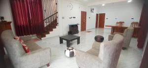 a living room with three chairs and a table at Me-Family in Matale