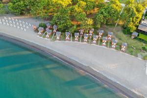 an aerial view of a beach with chairs and water at Akra Fethiye The Residence Tui Blue Sensatori - Ultra All Inclusive - Adults Only in Fethiye