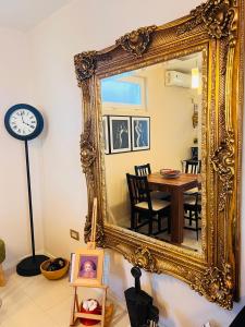 um grande espelho dourado numa sala de jantar com uma mesa em Studio Apartment 21 em Danilovgrad