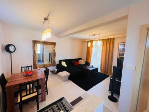 a living room with a black couch and a table at Studio Apartment 21 in Danilovgrad