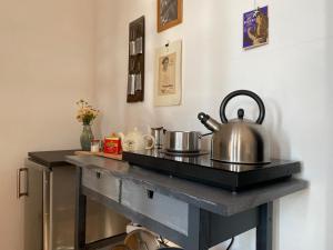 dwa garnki i patelnie na ladzie w kuchni w obiekcie Piccolo Nido in Alta Langa /Cosy Studio w mieście Levice