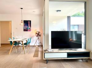 a living room with a large flat screen tv at Kirchberg Apartment - High End 2 Bedrooms in Luxembourg City in Luxembourg