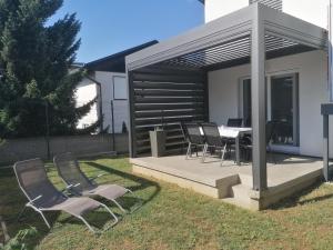a patio with a table and chairs in a yard at Apartment Sunset in Maribor