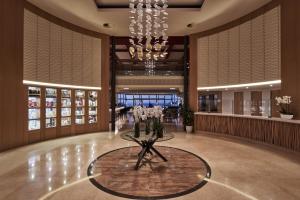 a lobby with a table with flowers on it at Atlantica Kalliston Resort - Adults Only in Stalos