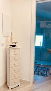 a toy boat sitting on a dresser in a room at Suite annarè, casa al mare, casa vacanza al mare in Sorrento