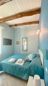 a bedroom with a blue bed in a room at Suite annarè, casa al mare, casa vacanza al mare in Sorrento
