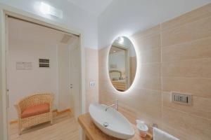a bathroom with a sink and a mirror at Relais Valle Dell'Idro - Rooftop & Sea View, Otranto in Otranto +74 photos
