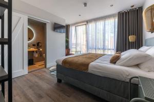 a bedroom with a large bed and a large window at Hotel La Boutique in Nijmegen