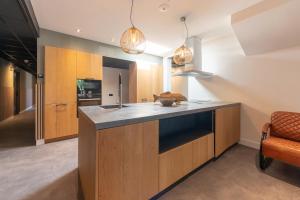 a kitchen with wooden cabinets and a counter top at Hotel La Boutique in Nijmegen