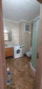 a bathroom with a washing machine and a toilet at İnce Apart Rezidence in Trabzon +64 photos