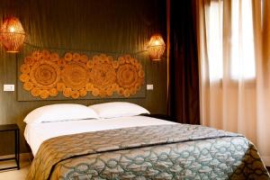 a bedroom with a large bed with a wooden headboard at Albergo Il Giardino in Rodi Garganico