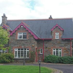 a brick house with a black roof at Rossclare Lodge in Enniskillen