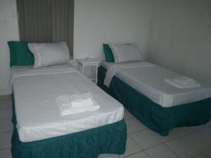 two twin beds in a room with at Stunning views at sky castles Ocho Rios in Eden Bowers