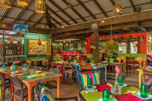 a restaurant with tables and chairs in a room at Stunning views at sky castles Ocho Rios in Eden Bowers