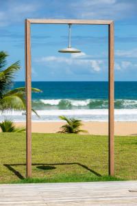 a wooden frame with a view of the beach at KA BRU 1100 Boutique Hotel in Taipu