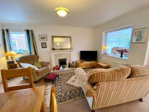 a living room with two couches and a tv at Spacious Two Bedroom House - TM in Southport