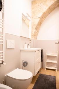 a bathroom with a white toilet and a sink at All’ombra del campanile in Tarquinia