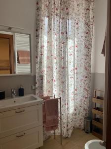 a bathroom with a sink and a shower curtain at All’ombra del campanile in Tarquinia +38 photos