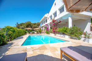 a swimming pool in front of a house at Villa Paradis in Les Issambres