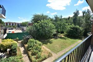a view of a garden from a balcony at London Zone 2 Two Bedroom Apartment in London