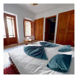 a bedroom with two beds with blue pillows on them at Palais Nejma oriental in Marrakesh