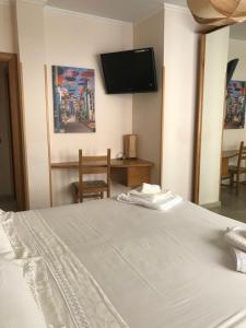 a bedroom with a bed and a flat screen tv at La torre in Velletri