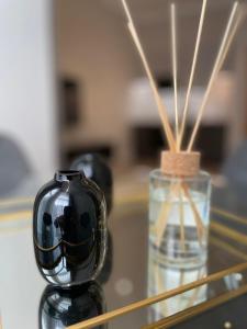 a black vase sitting on a glass table with a vase at Cleveland Residences Chelsea in London