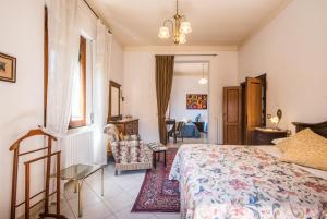 a bedroom with a bed and a living room at Villa in Pineta in Sinalunga