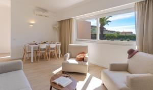 a living room with chairs and a table and a window at Pestana Alvor Beach Villas Seaside Resort in Alvor