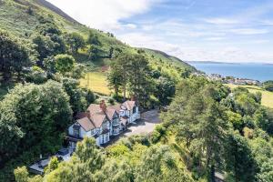 an aerial view of a house on a hill at Delightful holiday home with sea views and Hot Tub in Penmaen-mawr