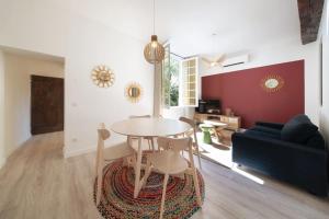 a living room with a table and a couch at LE FIGUIER - CLIM - WIFI in Villeneuve-lès-Avignon