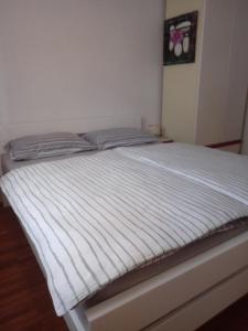 a bed in a bedroom with a white mattress at V klancu in Dekani