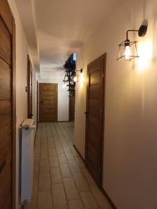 a hallway with doors and a tiled floor in a room at Ojców, Na Widoku in Ojców