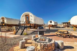 a group of tents with a table and a grill at Zion White Bison Glamping & RV Resort in Virgin