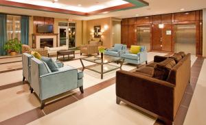 a living room with couches and chairs and a table at Holiday Inn Columbia East, an IHG Hotel in Columbia