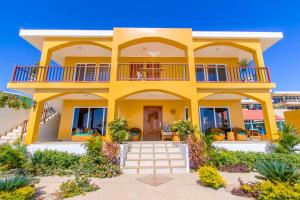 a yellow house with a balcony at Beso del Sol in Santa Marianita