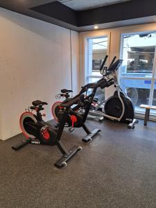 a gym with two exercise bikes in a room at Le 908, suberbe condo neuf avec piscine in Quebec City