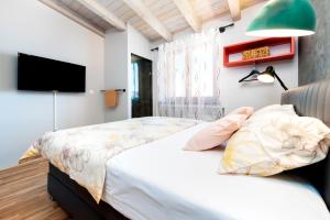 a bedroom with a bed and a flat screen tv at La picia in Rovinj