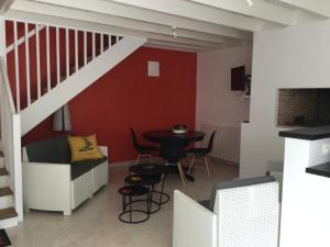 a living room with a staircase and a table at LA MABONNAIS in Pleurtuit