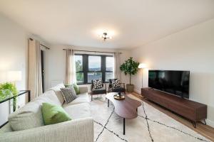 a living room with a couch and a flat screen tv at At The Castle in Broughty Ferry